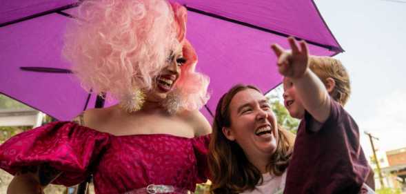 A drag queen with a mother and child