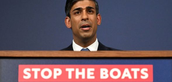 Rishi Sunak announcing the Illegal Migration Bill at a podium with the message "stop the boats".