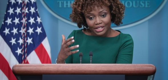 White House press secretary Karine Jean-Pierre wears a green outfit as she gestures with her hand while talking about Tennessee's anti-drag law