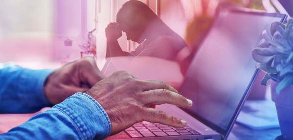 In the foreground, a pair of black hands are typing at a computer. In the background there is a silhouette of a distressed person..