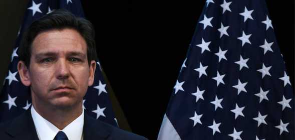 Ron DeSantis in front of United States flags