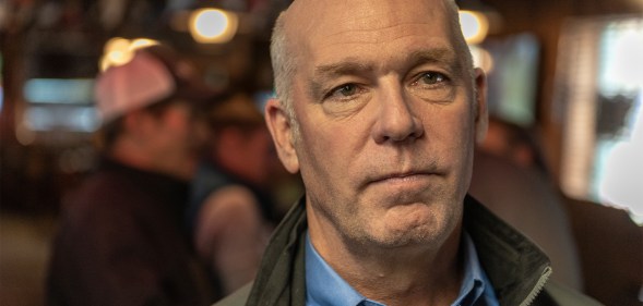 Montana governor Greg Gianforte wearing a jacket in a bar.