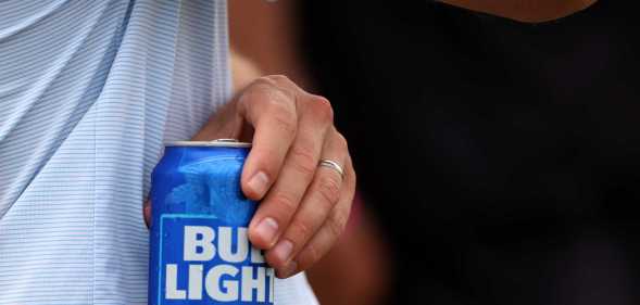 Man holds a Bud Light can