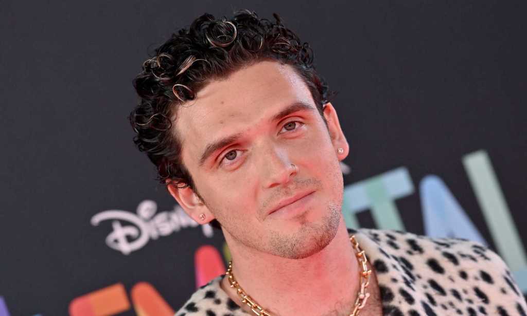 Pop singer Lauv wearing a spotted shirt with short dark hair.