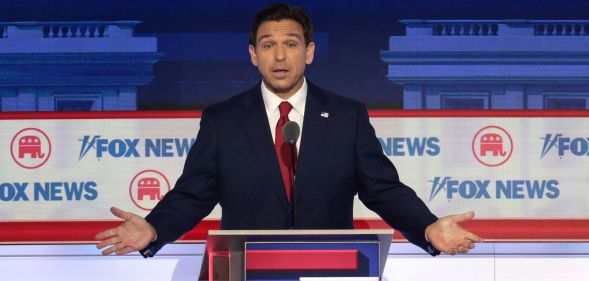 Florida governor Ron DeSantis stands behind a podium during the Republican presidential debate 2024