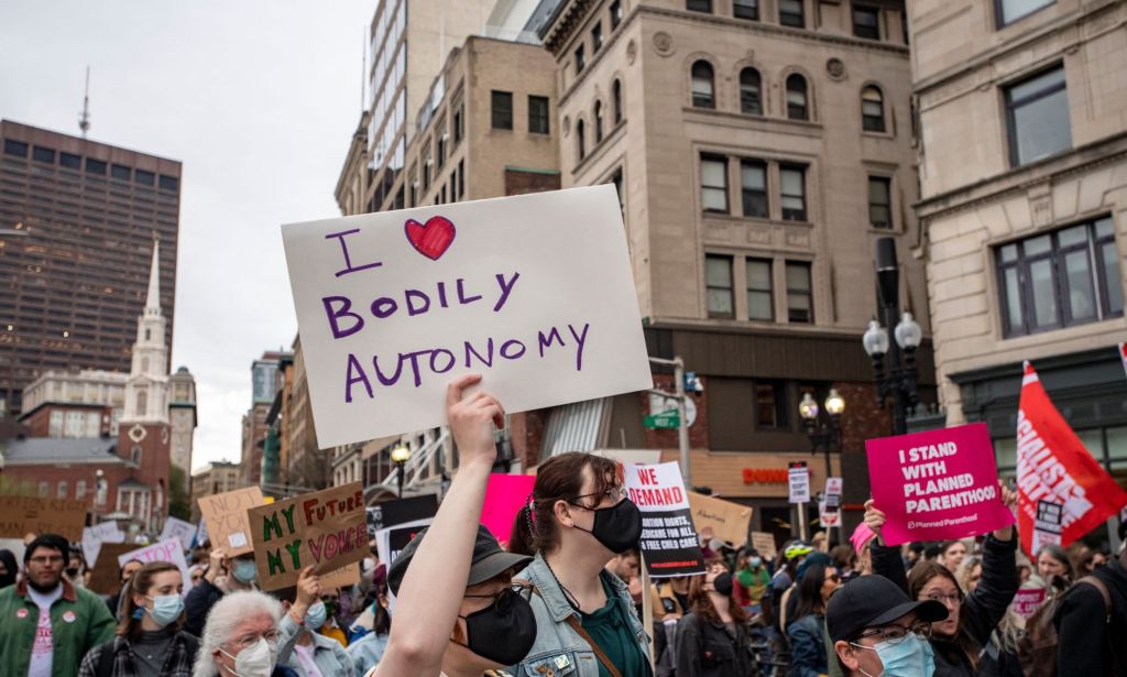 A person holds up a sign reading 'I (heart symbol) bodily autonomy' during a protest against the Supreme Court's ruling overturning abortion rights and attempts by right-wing lawmakers to ban gender-affirming healthcare