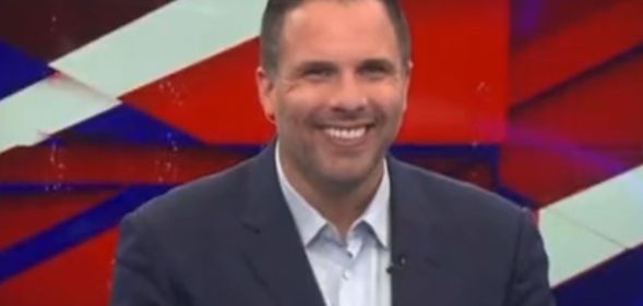 Dan Wootton in the GB News studio smiling.