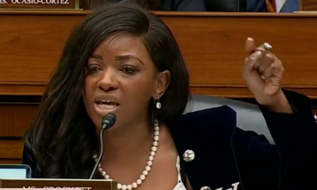 Jasmine Crocket raising her finger to enunciate a point during her speech at a Capitol Hill hearing.