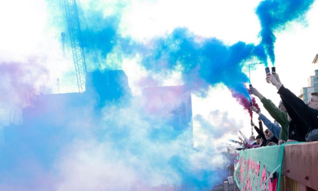 Activists set off smoke bombs in the colours of the transgender flag to protest the government's treatment of transgender people.