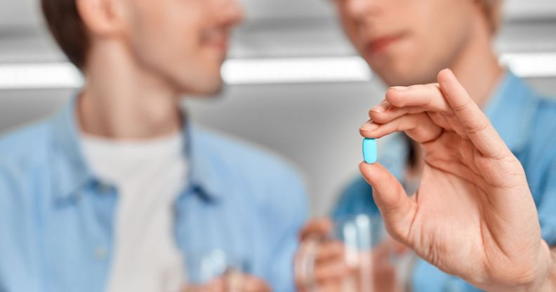 Generic image of a man holding a pill to illustrate a story about PrEP