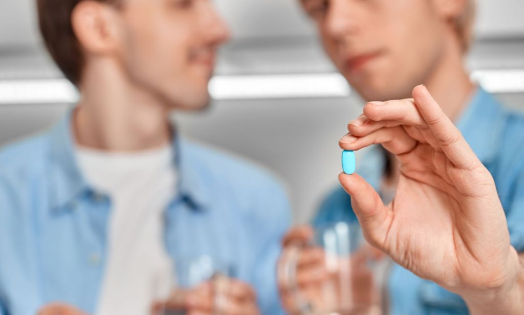 Generic image of a man holding a pill to illustrate a story about PrEP