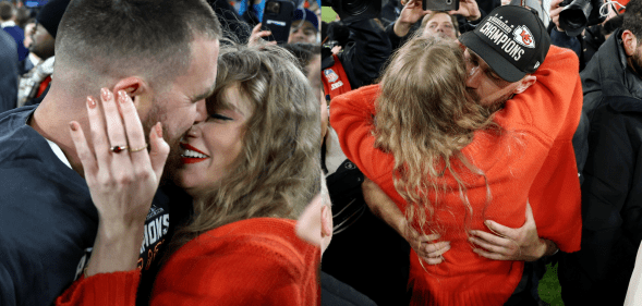 They served some serious PDA on the football field. (Patrick Smith/Getty Images)