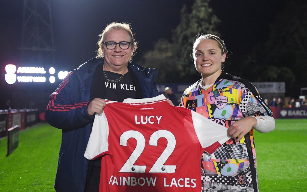 Lucy Clark is presented with a Rainbow Laces Arsenal home shirt by Kim Little, Captain of Arsenal prior to the Barclays FA Women's Super League match between Arsenal and West Ham United at Meadow Park on October 30, 2022 in Borehamwood, England. (Photo by Alex Burstow/Arsenal FC via Getty Images)