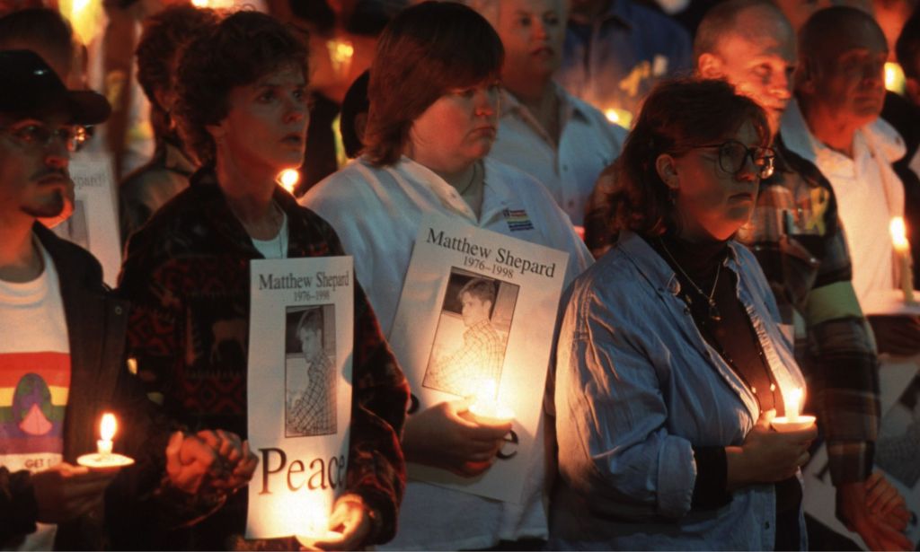 Protestors hold a candlelight vigil for Matthew Shepard.