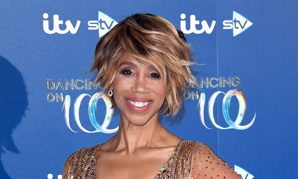 Trisha Goddard on the Dancing on Ice red carpet with a gem studded gown smiling at the camera.