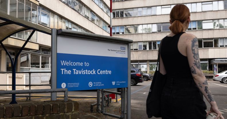 A person walking past the Tavistock Centre sign.