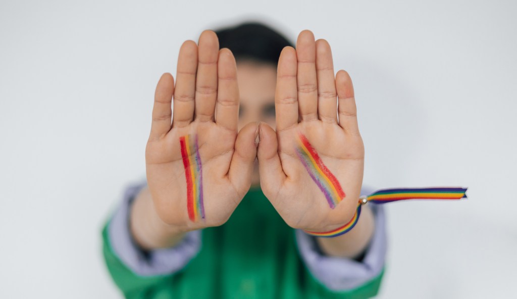 Child hands painted as rainbow flag LGBTQ+ (Getty)