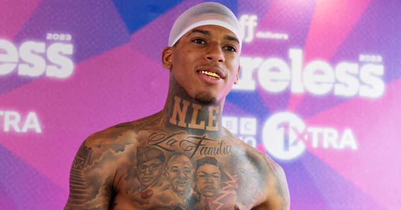 Rapper NLE Choppa smiles while topless at Wireless festival.