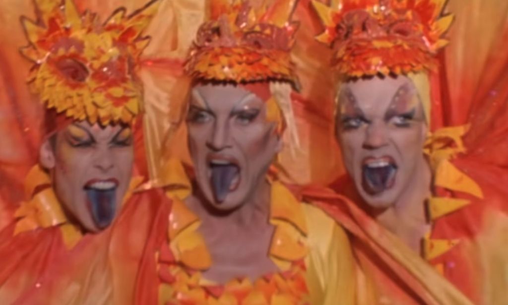 The main trio of Priscilla Queen of the Desert, sticking their tongues out during a performance in drag.