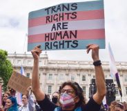 A protestor holds up a sign that reads "trans rights are human rights."