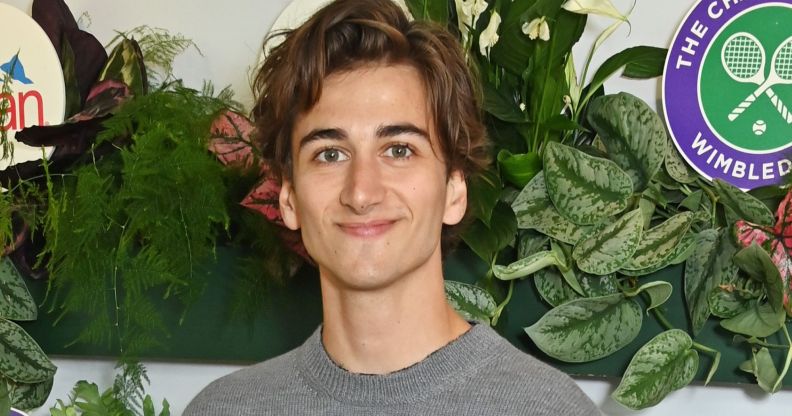 Sebastian Croft smiling in a grey top at Wimbledon.