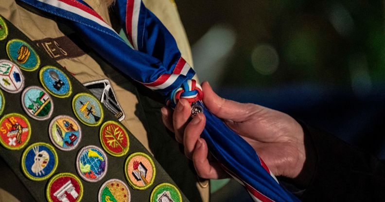 A person is holding a Boy Scout's tie.