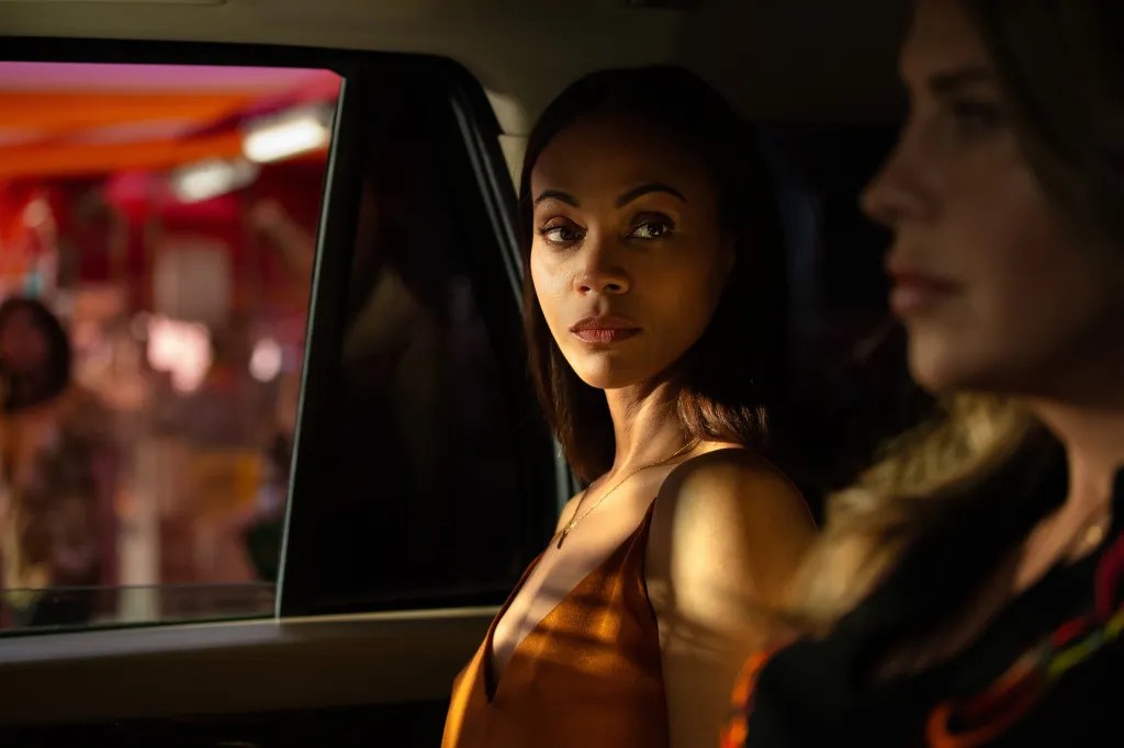 Zoe Saldaña stars Emilia Perez, looking across the car