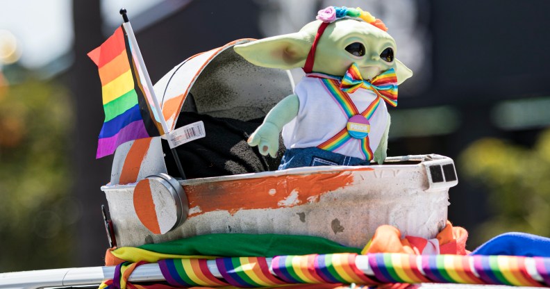 Photo taken at San Diago Pride showing Grogu from The Mandalorian in Pride themed rainbow outfit