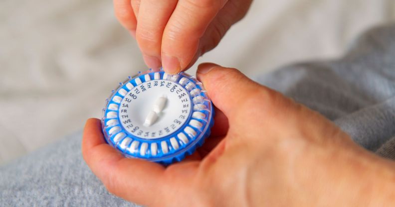 A person holding a hormone capsule.