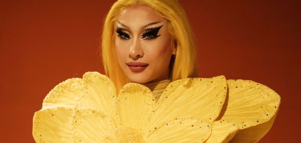 Drag Race winner Nymphia Wind in a yellow flower outfit.