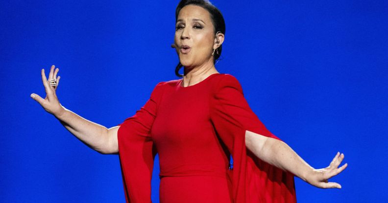 Eurovision Song Contest host Petra Mede in a red dress singing.