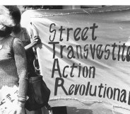 Sylvia Rivera with a Street Transvestite Action Revolutionaries banner.
