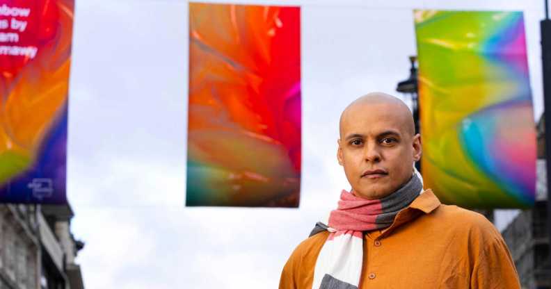Adham Faramawy stands in front of his reimagined Pride flags