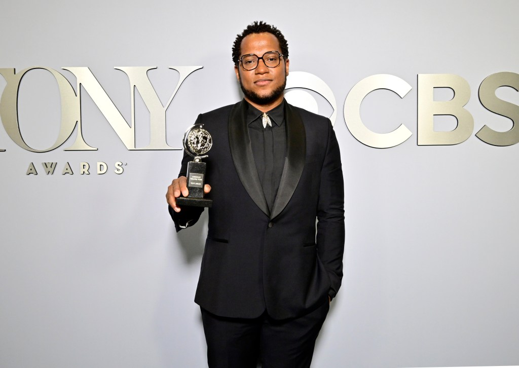 Branden Jacobs-Jenkins posing on the carpet with his Tony Award