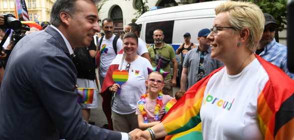 US Ambassador to Hungary David Pressman (L) greets participants as he takes part in the Budapest Pride Parade in Budapest, Hungary on June 22, 2024. (Photo by Ferenc ISZA / AFP) (Photo by FERENC ISZA/AFP via Getty Images)