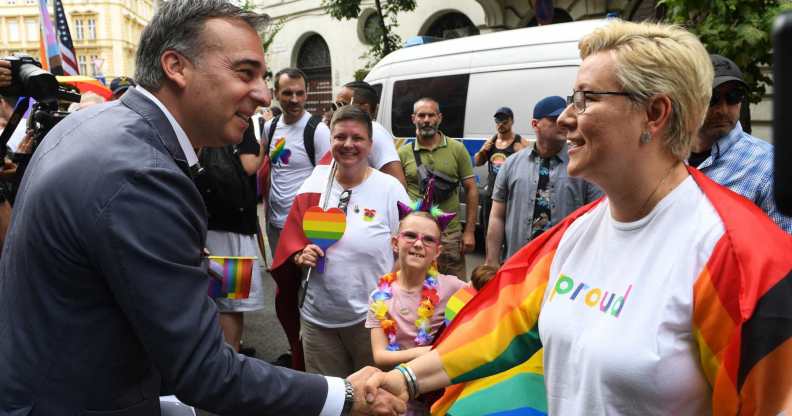US Ambassador to Hungary David Pressman (L) greets participants as he takes part in the Budapest Pride Parade in Budapest, Hungary on June 22, 2024. (Photo by Ferenc ISZA / AFP) (Photo by FERENC ISZA/AFP via Getty Images)