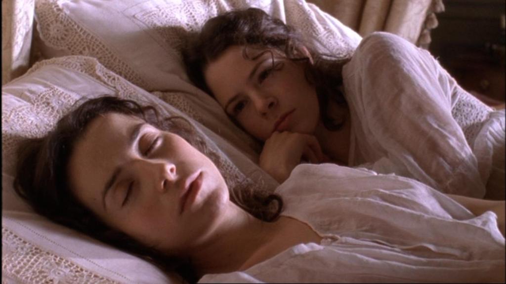 Fingersmith still, one woman asleep and the other awake staring at her.