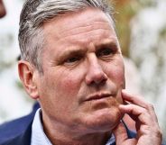 Keir Starmer scratching his face.