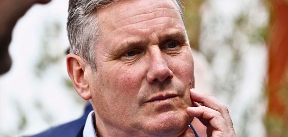 Keir Starmer scratching his face.