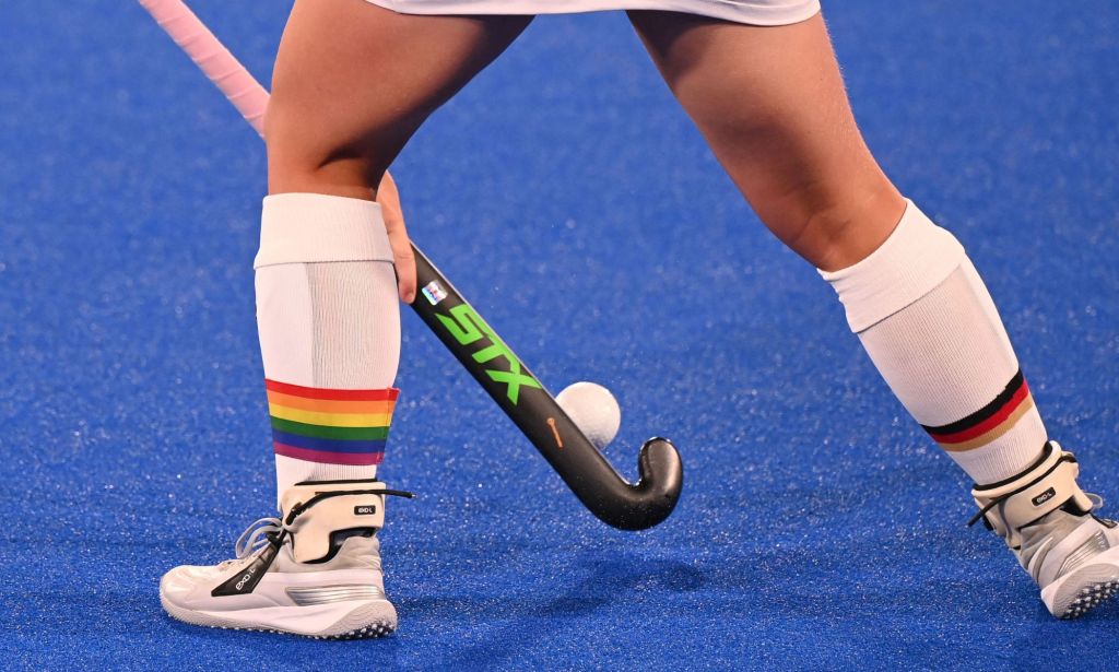 A person wearing LGBTQ+ socks during an Olympic event.