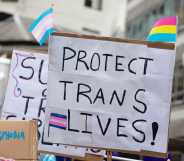 a placard reading protect trans lives