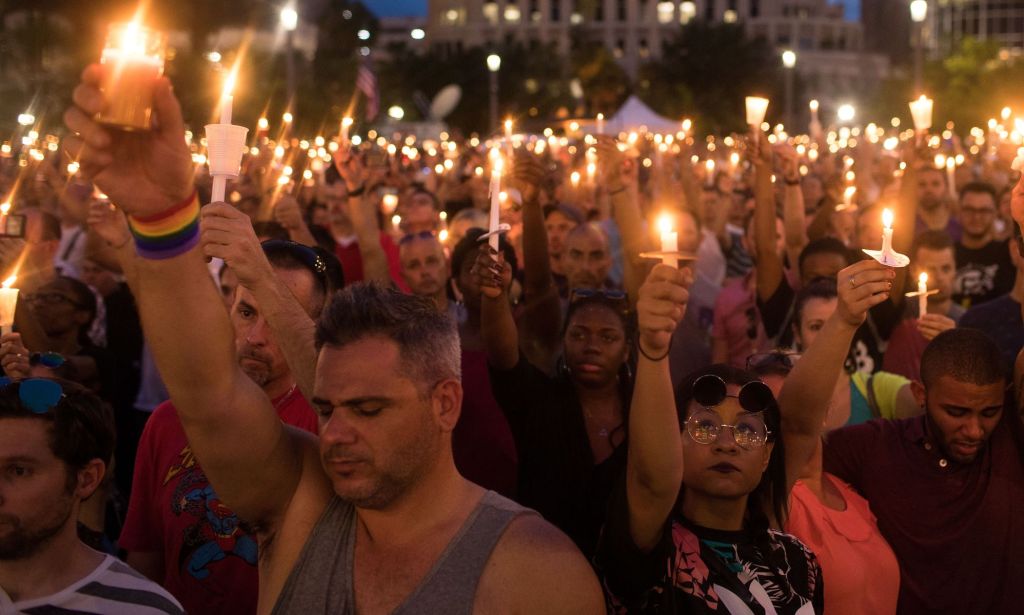 Crowds holding candles dedicated to those who died during the Pulse Nightclub shooting.