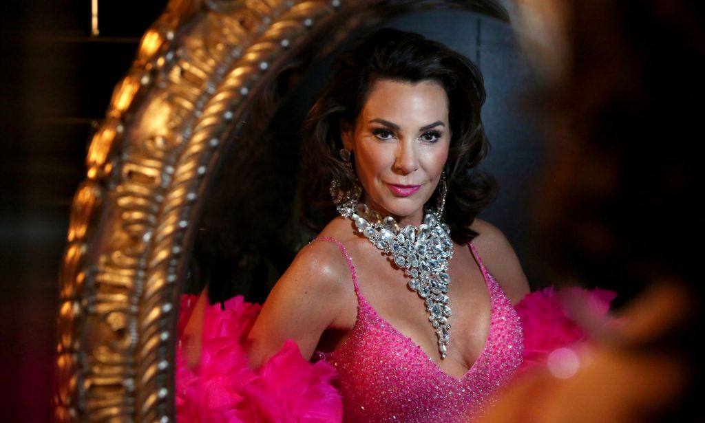 Countess Luann in silver necklace, pink dress and boa