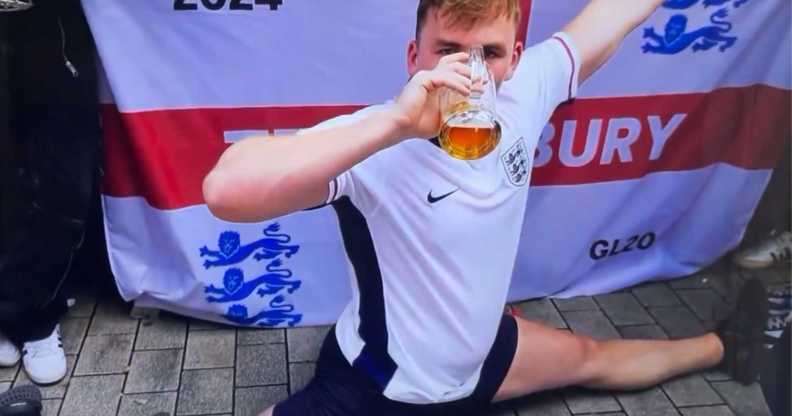 An England Euro 2024 supporter doing the splits and downing a pint