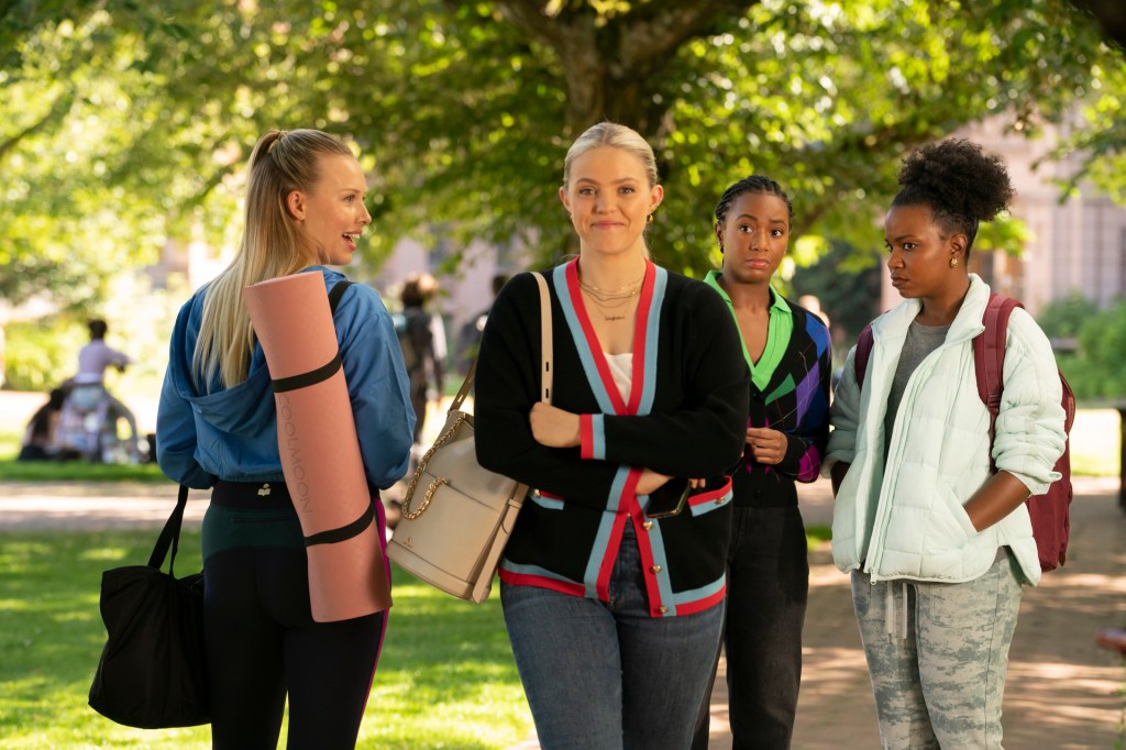 The Sex Lives of College Girls' Renee Rapp as Leighton, smiling as she walks past a group of young women.