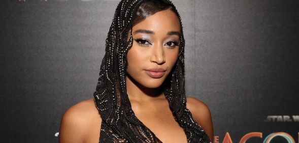 Amandla Stenberg wears a black lacy head covering while on the red carpet premiere of Star Wars: The Acolyte.