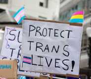 a sign reading 'protect trans lives'