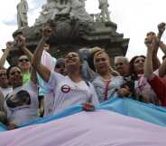 Activist Kenia Cuevas leads a demonstration at the Angel de la Independencia for the "Paola Buenrostro Law".