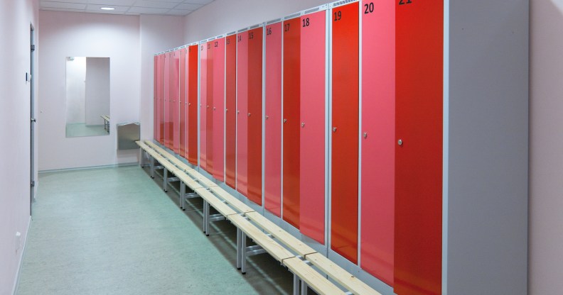 A locker room with a row of red lockers