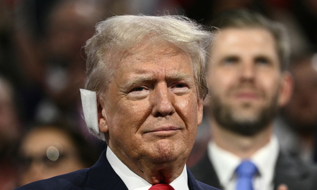 US former President and 2024 Republican presidential candidate Donald Trump at a rally with a bandage on his ear.